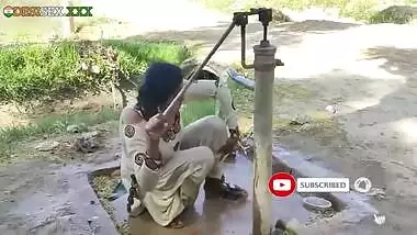 Young village school girl taking a bath in a sari and caught on camera