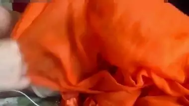 Middle-aged Indian diva in orange sari shows off her XXX titties