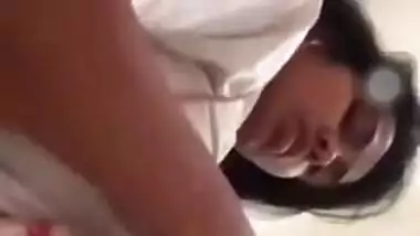 Girl performs XXX show and pulls up white T-shirt to expose boobs